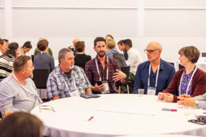 Delegates undertake a round table discussion in a workshop
